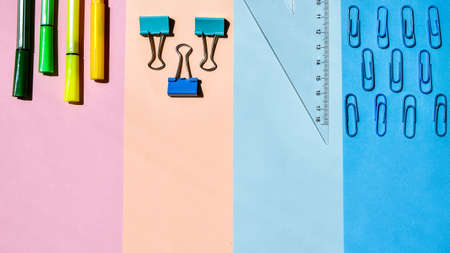School Supplies In Frame With Colorful Paper Background. School or office stationery on colorful background. Back to School. Frame, copy space. Top viewの写真素材