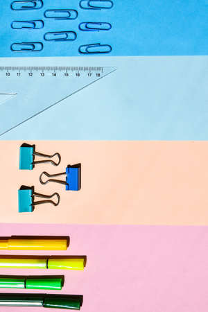 School Supplies In Frame With Colorful Paper Background. School or office stationery on colorful background. Back to School. Frame, copy space. Top viewの写真素材