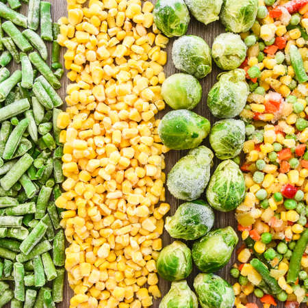 Different frozen vegetables as background, top view. Stocking up vegetables for winter storage. Assortment of frozen vegetables. Healthy food, Cooking ingredientsの写真素材