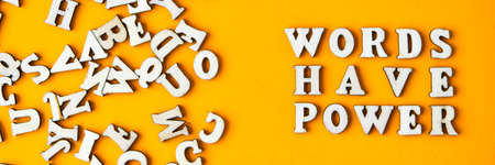 Quote WORDS HAVE POWER made out of wooden letters on bright yellow background. Motivational Words Quotes Conceptの写真素材
