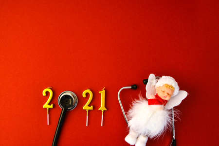 2021 year made of gold candles with medical stethoscope. Copy space. New year and Merry christmas medical concept. Healthy lifestyle. Hospital decorationsの写真素材