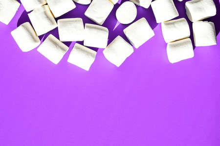 Marshmallows on purple background with Copy space. Flat lay. Top view. Background or texture of...