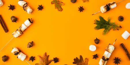 Christmas composition. Cinnamon marshmallows leaves and anise on yellow background. Fall...