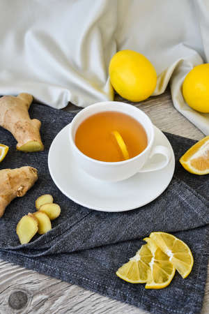 Ginger hot immunity boosting Vitamin natural drink With citrus lemon cinnamon anise in a rustic style on wooden background. Chamomile tea. Healthy conceptの写真素材