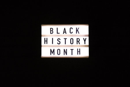 Lightbox with text BLACK HISTORY MONTH on dark black background. Message historical event. Lightの写真素材