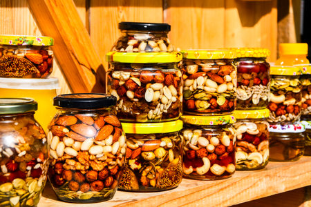 The delicious vitamins are filled with natural honey and cans on the shelves. Walnuts and peanuts in...