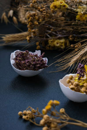 Easter DIY. Do it yourself. Trendy Easter decorations. Cracked organic eggs with dry grass and dry...