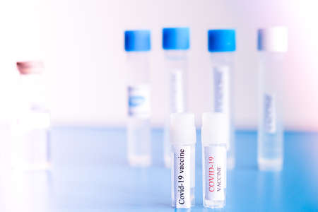 Ampoules Covid-19 vaccine on a laboratory bench. Fight the coronavirus, sars-cov-2 pandemic....