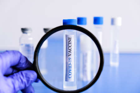 Ampoules Covid-19 vaccine on a laboratory bench. Fight the coronavirus, sars-cov-2 pandemic....