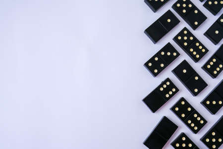 Black old, vintage dominoes on white background. The concept of the game dominoes. Selective focus....