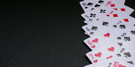Playing cards on black background with copy space. Stay home leisure activity for family and friends. Frame with playing cards. Poker cards. Posterの写真素材