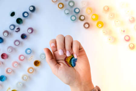 Rainbow LGBTQ flag painted on hand. Support for lgbt community. Honor of pride month. Connecting people, touching hands. Multi colored hands art creativity, discrimination.の写真素材