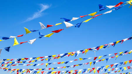 multi colored party rainbow flags on blue sky for celebration. Flags Colors Blue Sky. Color party flags festivalの写真素材