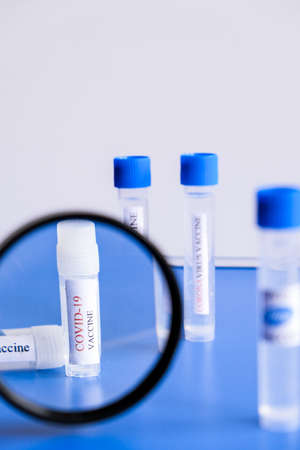 Ampoules Covid-19 vaccine on a laboratory bench. Fight the coronavirus, sars-cov-2 pandemic. Coronavirus 2019-nCoV COVID concept.の写真素材