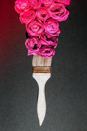 Paint brush drawing with pink flowers on black background. The concept of spring and international womens mothers day. Floral painting and decoration creative. Peonies rosesの写真素材