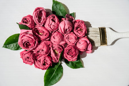 Paint brush drawing with pink flowers on white background. The concept of spring and international...