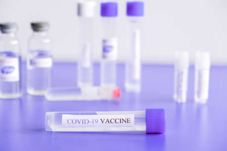 Ampoules Covid-19 vaccine on a laboratory bench. Fight the coronavirus, sars-cov-2 pandemic. Coronavirus 2019-nCoV COVID concept. Vaccinationの写真素材