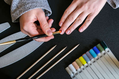 Work at home with nails. Nail care, Self care. Female manicure. Do manicure by yourself while staying at home. Woman female hands, manicure toolsの写真素材