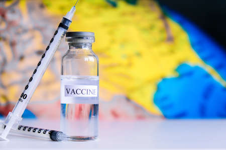 Syringe Ampoules  vaccine on a world map. Fight the , sars-cov-2 pandemic.  concept. Vaccinationの写真素材