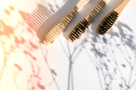 Bamboo toothbrush. Biodegradable, organic on a white background with deep trendy shadows. Eco friendly life style concept, zero wasteの写真素材