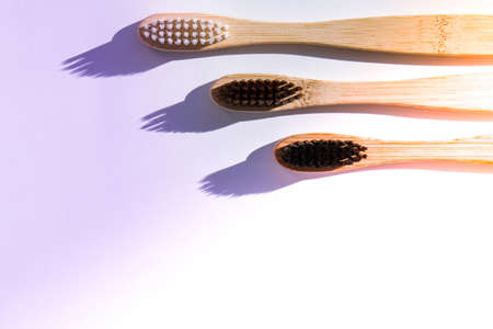 Bamboo toothbrush. Biodegradable, organic on a white background with deep trendy shadows. Eco friendly life style concept, zero wasteの写真素材