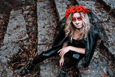 Closeup portrait of Calavera Catrina. Young woman with sugar skull makeup. Dia de los muertos. Day...