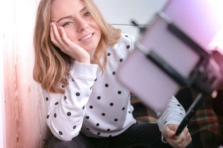 Blogging. Blonde girl blogger Technology internet and happiness concept. Young woman funny girl...
