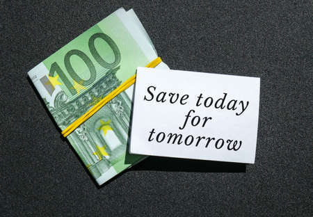 Paper note written text SAVINGS. Save money. Save today for tomorrow Euro banknotes. Money,...