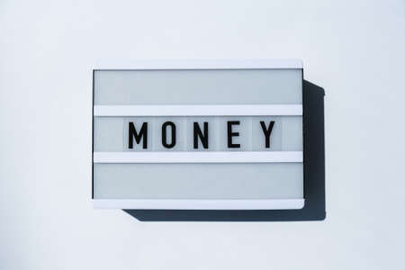 Lightbox board on a white background with the words MONEY in black letters. Currency, cashの写真素材