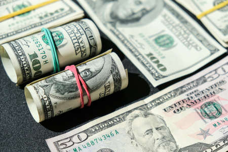 US dollars bundle close up isolated on dollar background. Paper denominations of dollars cash rolls...