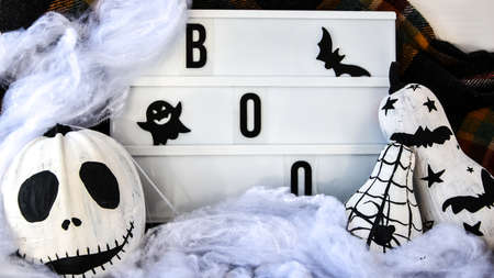 Lightbox with text BOO Halloween background with painted face pumpkins and autumn leaves. Diy. Do it...