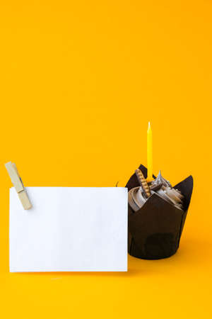 Delicious chocolate cupcake with cream and candle on dark background. Chocolate muffin. Birthday cake party. Homemade bakery. Copy space greeting cardの写真素材