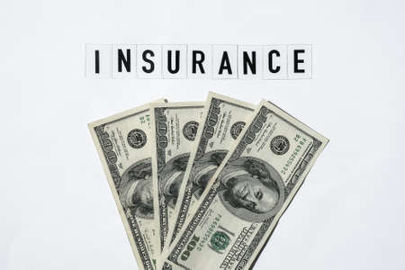 Text INSURANCE around US dollar banknotes.