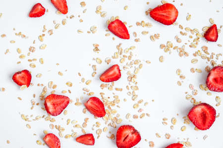 Oatmeal porridge with fresh strawberries on light table. Healthy diet breakfast, vegan or vegeterian...