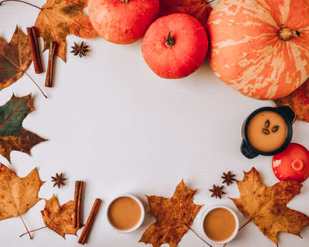 Autumn food. Frame of pumpkin puree soup, leaves. Top view. Autumn harvest, pumpkins, leaves on gray...