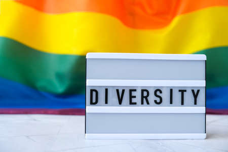 Rainbow flag with lightbox and text DIVERSITY. Rainbow lgbtq flag made from silk material. Symbol of...