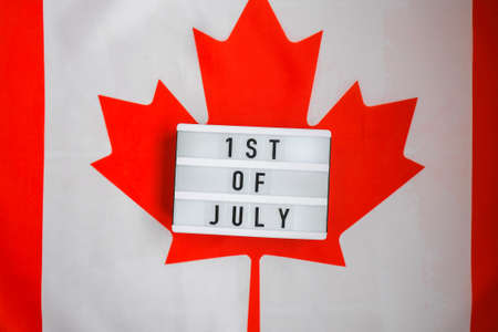 The National Flag of Canada. Lightbox with text 1ST OF JULY Canadian Flag or the Maple Leaf. Patriotism. International relations concept. Independence day. Immigrationの写真素材