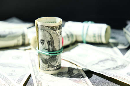 US dollars bundle close up isolated on dollar background. Paper denominations of dollars cash rolls with rubber bands. Business budget of wealth and prosperity finance. Pile capital of American US dollars bills notes cashの写真素材