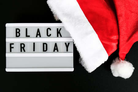 Lightbox with text BLACK FRIDAY around christmas new year decoration. Santas hat. Sale shopping concept. Template Black friday sale mockup fall promotion advertising. Holiday Big sale. Cyber monday.の写真素材