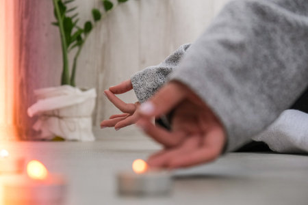 Close-up. Woman doing yoga exercise at home. Mindfulness meditation. Relax breathe easy pose gym...