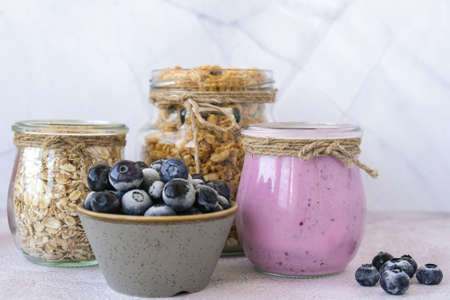 Blueberry smoothie topped with blueberries. A glass of breakfast protein smoothie drink made from pureed raw blueberries, banana, milk, yogurt, and cottage cheese. Vegetarian vegan foodの写真素材