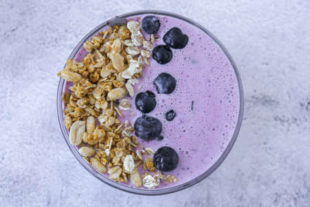 Healthy blueberry smoothie bowl with blueberries, chia seeds and granola. Healthy vegan vegetarian breakfast. Nutrition and dieting. Super food antioxidantの写真素材