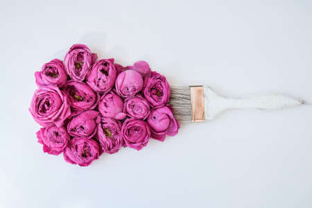 Paint brush drawing with pink flowers on white background. The concept of spring and international...