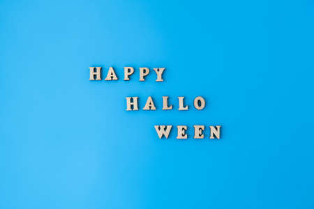 Happy halloween text made of wooden letters on blue background. Greeting cardの写真素材
