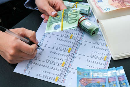 Working businesswoman hand at office workplace desk. Counting money for salary. Investment savings. Finances, economy and home concept. Business budget of wealth and prosperity finance. Workspace officeの写真素材