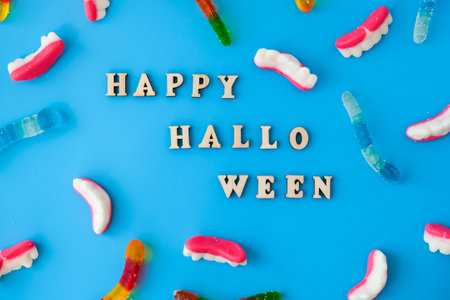 Halloween concept. Halloween party decorations with words Happy Halloween, sweets, top view flat lay...