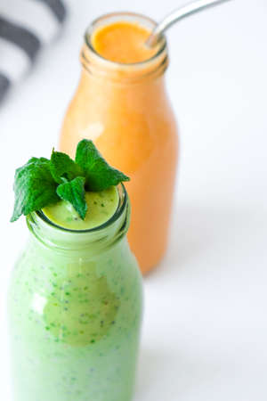 Seasonal Matcha green vegan smoothie with chia seeds and mint pumpkin carrot smoothie drink detox Breakfast. Clean eating, weight loss, healthy dieting food concept Fruit vegetable drink fitnessの写真素材