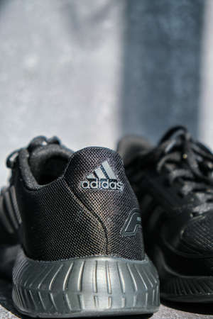 Kiev Ukraine - October 2021 Black Adidas Running boots. Multinational company. Product shots. Adidas swift run shoes for running for woman - illustrative editorial. Unisex for women and menのeditorial素材