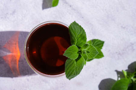 Tea with mint. Transparent cup of herbal tea with fresh mint. Healthy melissa tea natural organic aromatic drink in glass cup. Copy spaceの写真素材