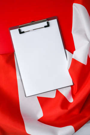 The National Flag of Canada. Canadian Flag or the Maple Leaf with empty paper note Copy space. Tourist traveler or patriotism. International relations concept. Independence day. Immigrationの写真素材